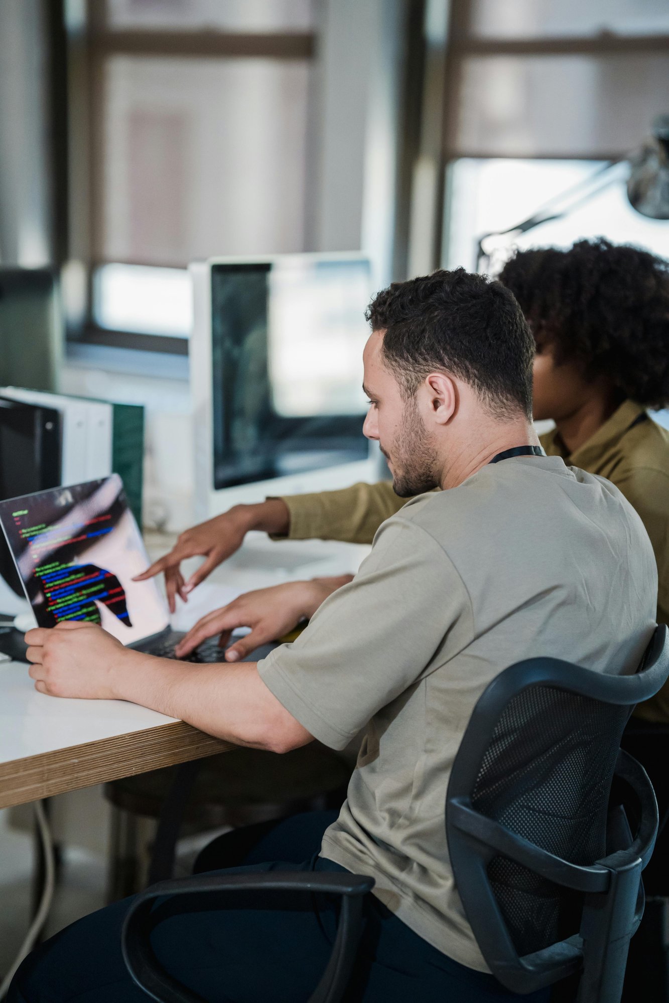 man and woman looking at computer